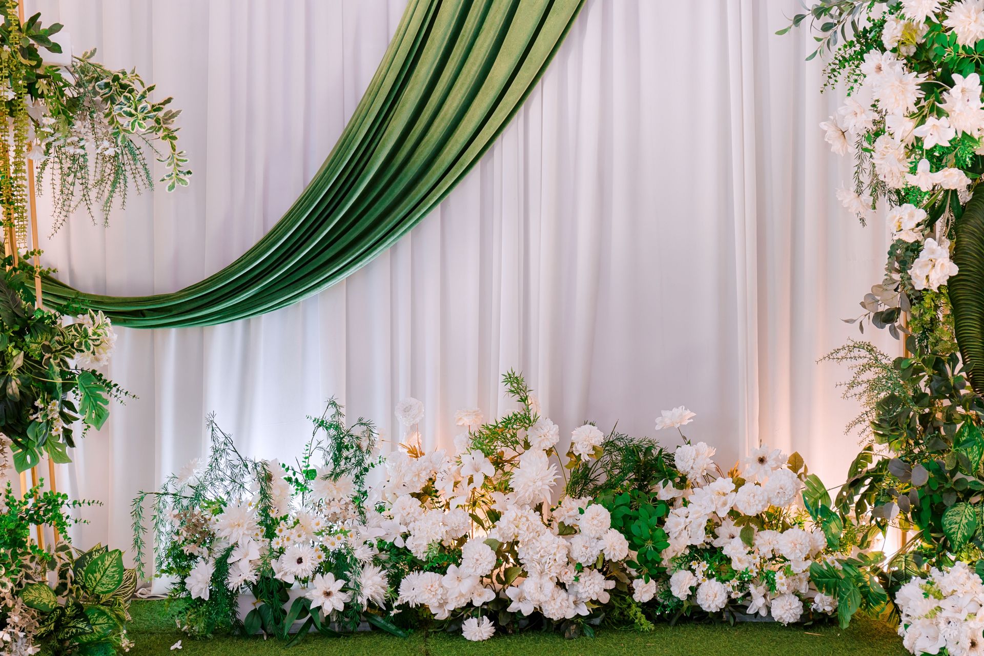 A sophisticated floral arrangement with lush greenery and white flowers, perfect for events.